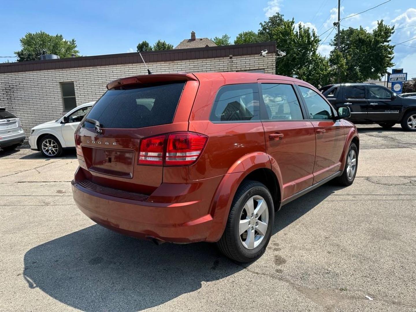 2013 ORANGE DODGE JOURNEY SE (3C4PDCAB0DT) with an 2.4L engine, Automatic transmission, located at 1708 Broadway, Rockford, IL, 61104, (815) 397-5010, 42.252522, -89.069359 - Photo#2